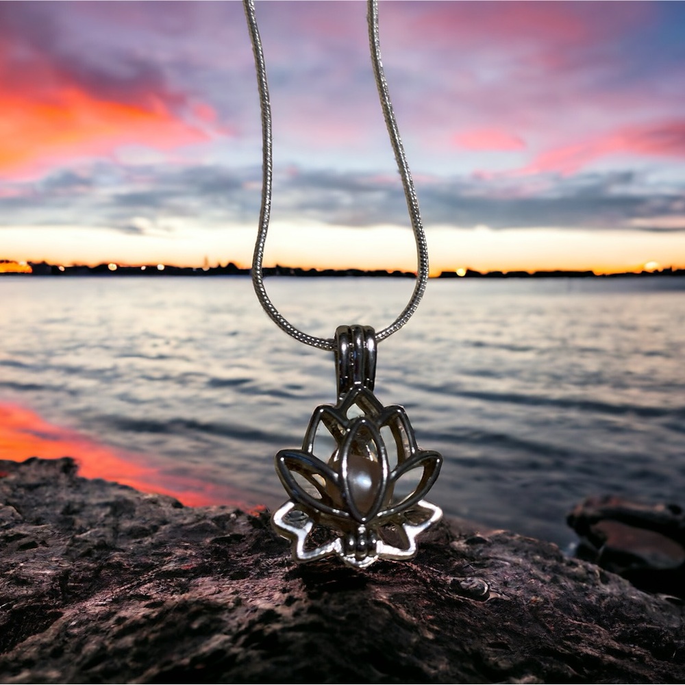 Lotus cage necklace with genuine pearl inside.